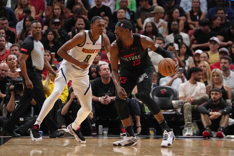 MIAMI, FL - MARCH 13: Bam Adebayo #13 of the Miami Heat dribbles the ball during the game against the Denver Nuggets on March 13, 2024 at Kaseya Center in Miami, Florida. NOTE TO USER: User expressly acknowledges and agrees that, by downloading and or using this Photograph, user is consenting to the terms and conditions of the Getty Images License Agreement. Mandatory Copyright Notice: Copyright 2024 NBAE (Photo by Eric Espada/NBAE via Getty Images)