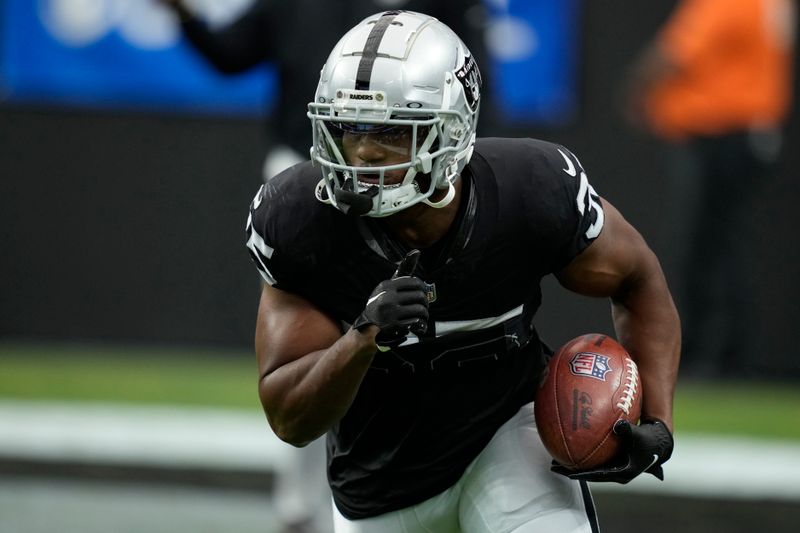 Las Vegas Raiders running back Zamir White (35) warms up before an NFL football game against the New England Patriots, Sunday, Oct. 15, 2023, in Las Vegas. (AP Photo/John Locher)