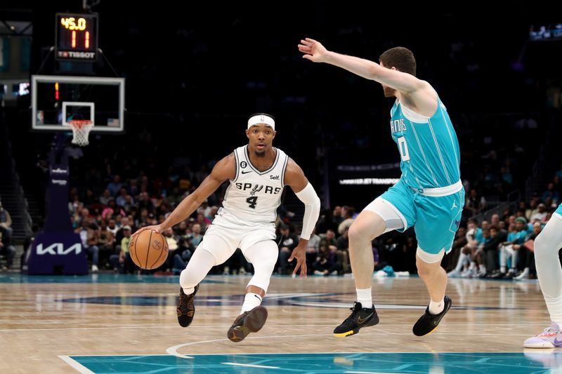 CHARLOTTE, NC - FEBRUARY 15: Devonte' Graham #4 of the San Antonio Spurs drives to the basket during the game against the Charlotte Hornets on February 15, 2023 at Spectrum Center in Charlotte, North Carolina. NOTE TO USER: User expressly acknowledges and agrees that, by downloading and or using this photograph, User is consenting to the terms and conditions of the Getty Images License Agreement.  Mandatory Copyright Notice:  Copyright 2023 NBAE (Photo by Brock Williams-Smith/NBAE via Getty Images)