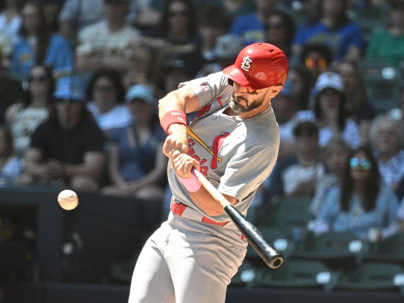 May 12, 2024; Milwaukee, Wisconsin, USA; St. Louis Cardinals designated hitter Matt Carpenter (13) gets a base hit against the Milwaukee Brewers in the first inning at American Family Field. Mandatory Credit: Michael McLoone-USA TODAY Sports