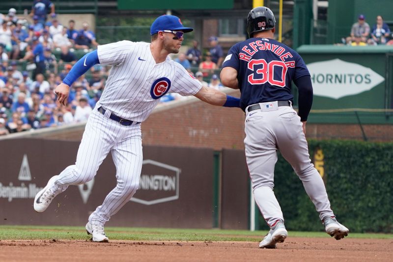 Jul 16, 2023; Chicago, Illinois, USA; Chicago Cubs shortstop Nico Hoerner (2) tags out Boston Red Sox center fielder Rob Refsnyder (30) during the first inning at Wrigley Field. Mandatory Credit: David Banks-USA TODAY Sports