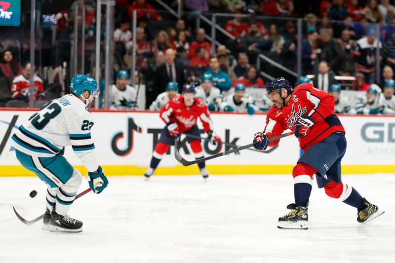 Jan 15, 2026; Washington, District of Columbia, USA; Washington Capitals left wing Alex Ovechkin (8) shoots the puck as San Jose Sharks center Barclay Goodrow (23) defends during the first period at Capital One Arena. Mandatory Credit: Geoff Burke-Imagn Images