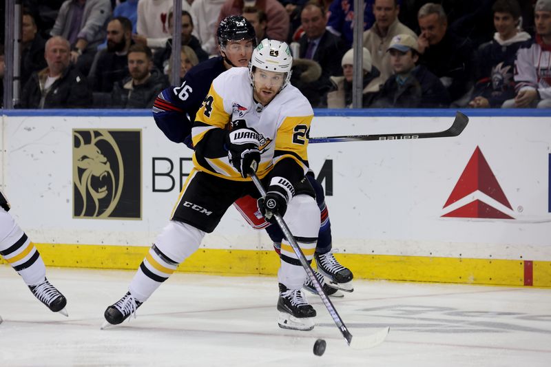 Dec 6, 2024; New York, New York, USA; Pittsburgh Penguins defenseman Matt Grzelcyk (24) plays the puck against New York Rangers left wing Jimmy Vesey (26) during the third period at Madison Square Garden. Mandatory Credit: Brad Penner-Imagn Images