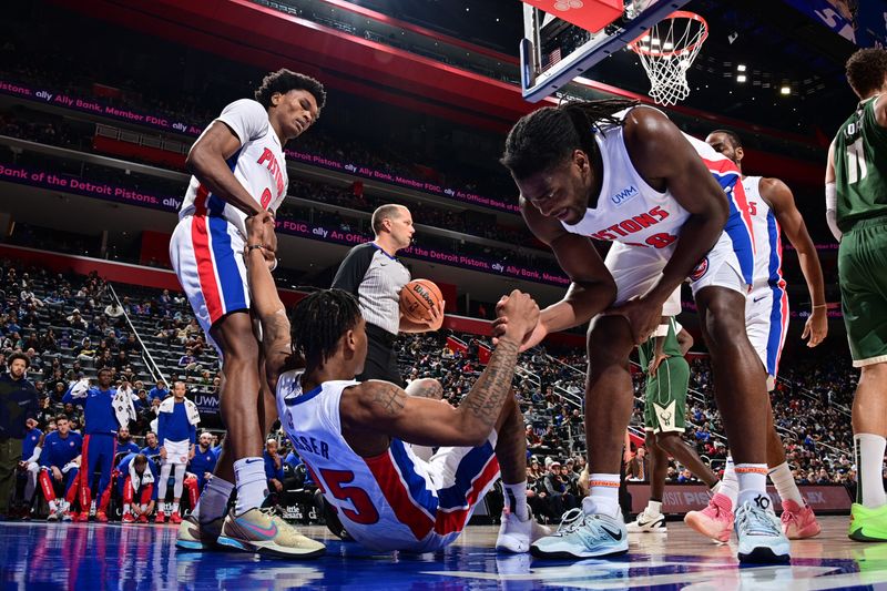 DETROIT, MI - JANUARY 22: Marcus Sasser #25 helped up by Ausar Thompson #9 and Isaiah Stewart #28 of the Detroit Pistons during the game against the Milwaukee Bucks on January 22, 2024 at Little Caesars Arena in Detroit, Michigan. NOTE TO USER: User expressly acknowledges and agrees that, by downloading and/or using this photograph, User is consenting to the terms and conditions of the Getty Images License Agreement. Mandatory Copyright Notice: Copyright 2024 NBAE (Photo by Chris Schwegler/NBAE via Getty Images)