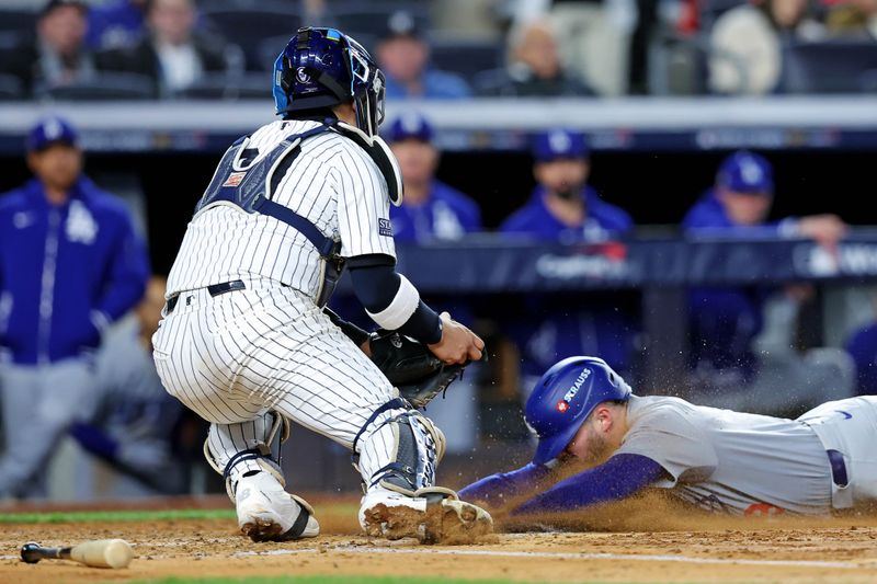 Oct 28, 2024; New York, New York, USA; New York Yankees catcher Jose Trevino (39) tags out Los Angeles Dodgers second baseman Gavin Lux (9) at home plate during the fourth inning in game three of the 2024 MLB World Series at Yankee Stadium. Mandatory Credit: Brad Penner-Imagn Images