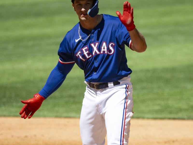 Mar 26, 2024; Arlington, Texas, USA; Texas Rangers left field Wyatt Langford (82) celebrates after he hits a double against the Boston Red Sox during the fourth inning at Globe Life Field. Mandatory Credit: Jerome Miron-USA TODAY Sports