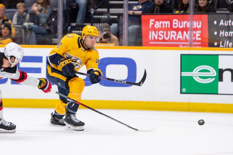 Feb 13, 2024; Nashville, Tennessee, USA;    Nashville Predators left wing Egor Afanasyev (70) takes a shot on goal against the New Jersey Devils during the third period at Bridgestone Arena. Mandatory Credit: Steve Roberts-USA TODAY Sports