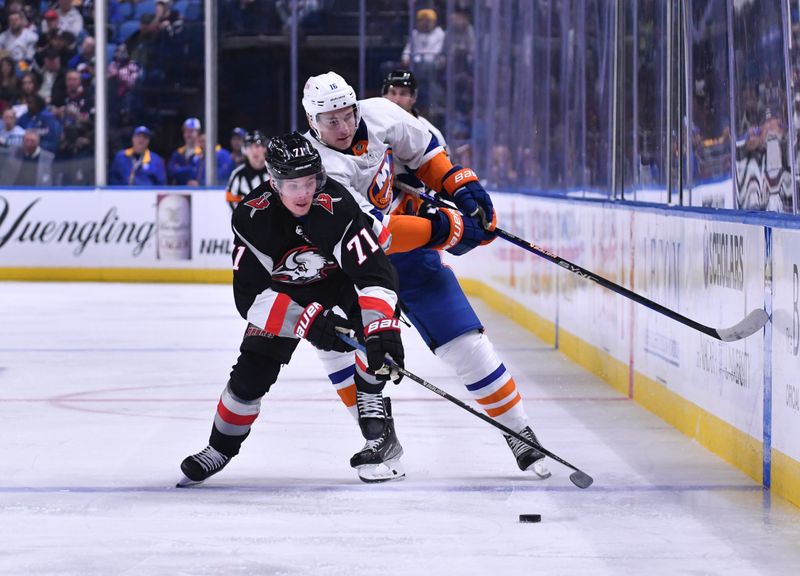 Oct 21, 2023; Buffalo, New York, USA; Buffalo Sabres left wing Victor Olofsson (71) and New York Islanders right wing Julien Gauthier (16) battle for the puck in the second period at KeyBank Center. Mandatory Credit: Mark Konezny-USA TODAY Sports