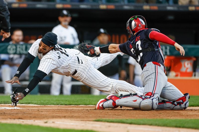 Apr 30, 2024; Chicago, Illinois, USA; Chicago White Sox catcher Martín Maldonado (15) is tagged out by Minnesota Twins catcher Ryan Jeffers (27) at home plate during the third inning at Guaranteed Rate Field. Mandatory Credit: Kamil Krzaczynski-USA TODAY Sports