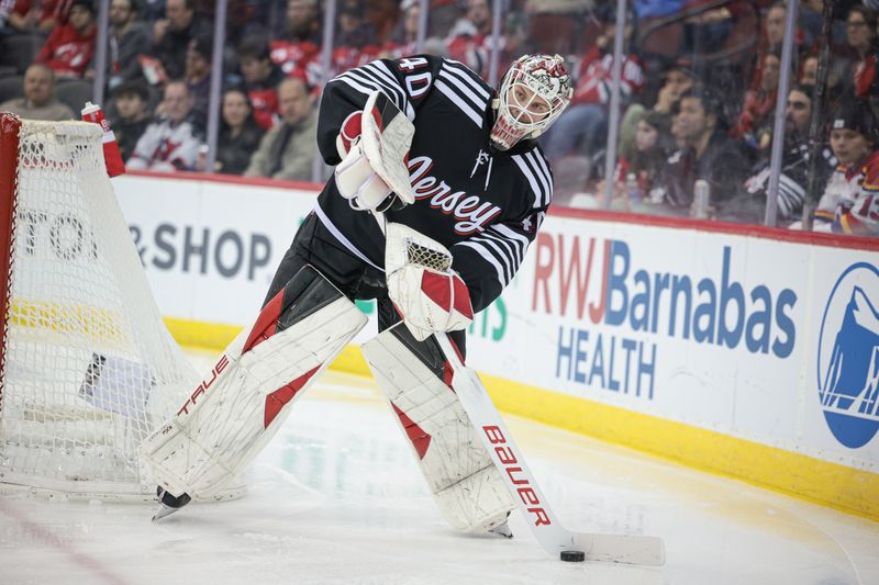 Dec 1, 2023; Newark, New Jersey, USA; New Jersey Devils goaltender Akira Schmid (40) plays the puck during the second period against the San Jose Sharks at Prudential Center. Mandatory Credit: Vincent Carchietta-USA TODAY Sports