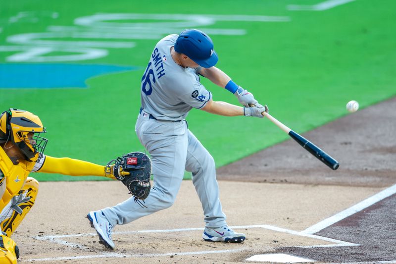 Jun 9, 2025; San Diego, California, USA; Los Angeles Dodgers catcher Will Smith (16) hits a sacrifice fly during the first inning against the San Diego Padres at Petco Park. Mandatory Credit: David Frerker-Imagn Images