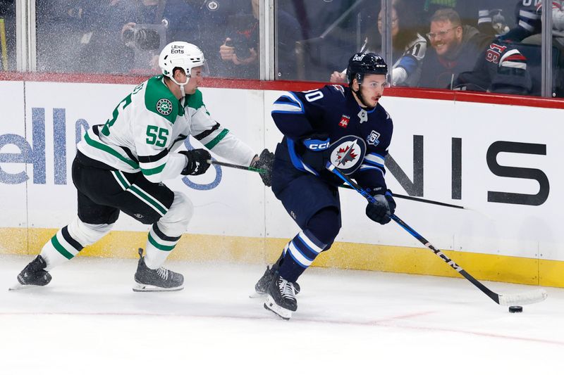 Oct 9, 2025; Winnipeg, Manitoba, CAN; Winnipeg Jets right wing Nikita Chibrikov (90) is checked by Dallas Stars defenseman Thomas Harley (55) in the third period at Canada Life Centre. Mandatory Credit: James Carey Lauder-Imagn Images