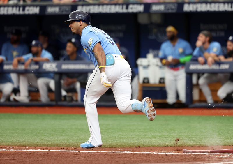 May 28, 2023; St. Petersburg, Florida, USA; Tampa Bay Rays shortstop Wander Franco (5) hits an RBI double during the second inning against the Los Angeles Dodgers at Tropicana Field. Mandatory Credit: Kim Klement-USA TODAY Sports