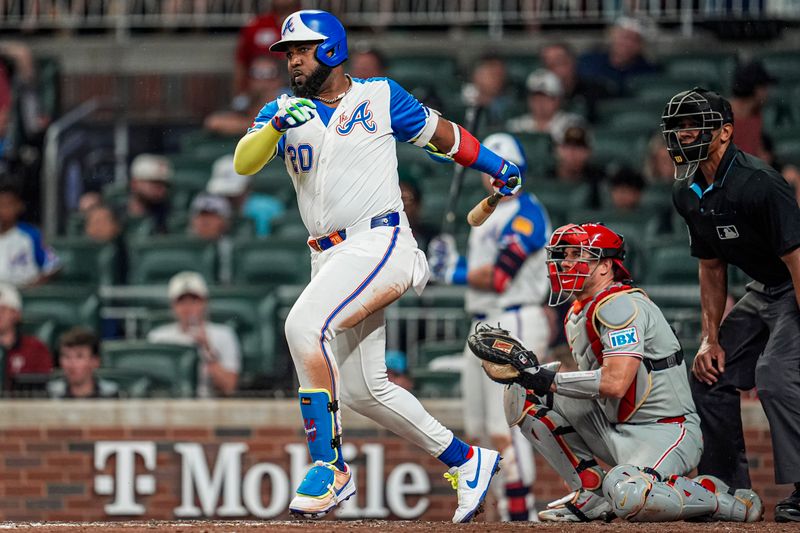 Jun 28, 2025; Cumberland, Georgia, USA; Atlanta Braves designated hitter Marcell Ozuna (20) singles against the Philadelphia Phillies during the seventh inning at Truist Park. Mandatory Credit: Dale Zanine-Imagn Images