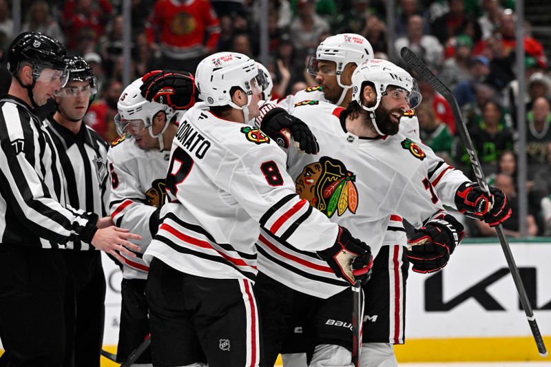 Oct 26, 2024; Dallas, Texas, USA; Chicago Blackhawks center Craig Smith (15) and left wing Pat Maroon (77) and defenseman Nolan Allan (42) and center Ryan Donato (8) celebrates a goal scored by Smith against the Dallas Stars during the third period at the American Airlines Center. Mandatory Credit: Jerome Miron-Imagn Images