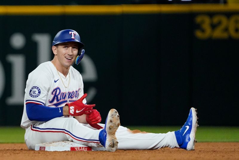 Jul 22, 2024; Arlington, Texas, USA; Texas Rangers left fielder Wyatt Langford (36) sits on second base after hitting a double during the ninth inning against the Chicago White Sox at Globe Life Field. Mandatory Credit: Raymond Carlin III-USA TODAY Sports