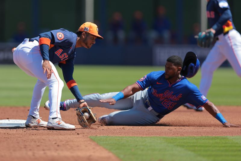 Mar 11, 2025; West Palm Beach, Florida, USA; Houston Astros shortstop Jeremy Pena (3) tags out New York Mets right fielder Alexander Canario (25) during a steal attempt in the second inning at CACTI Park of the Palm Beaches. Mandatory Credit: Sam Navarro-Imagn Images