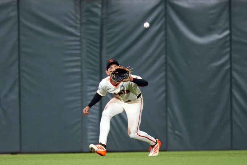 Jun 2, 2025; San Francisco, California, USA; San Francisco Giants center fielder Jung Hoo Lee (51) makes the catch of a line drive by San Diego Padres shortstop Xander Bogaerts during the ninth inning at Oracle Park. Mandatory Credit: D. Ross Cameron-Imagn Images
