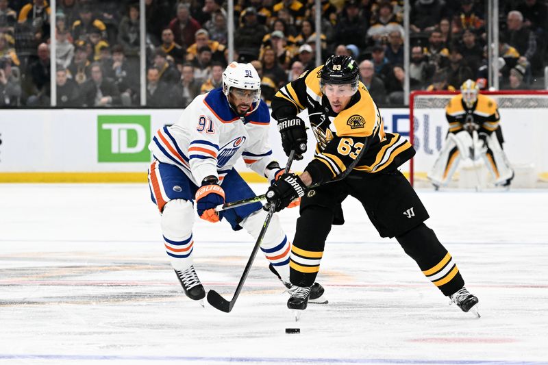 Mar 9, 2023; Boston, Massachusetts, USA; Boston Bruins left wing Brad Marchand (63) controls the puck in front of Edmonton Oilers left wing Evander Kane (91) during the third period at the TD Garden. Mandatory Credit: Brian Fluharty-USA TODAY Sports