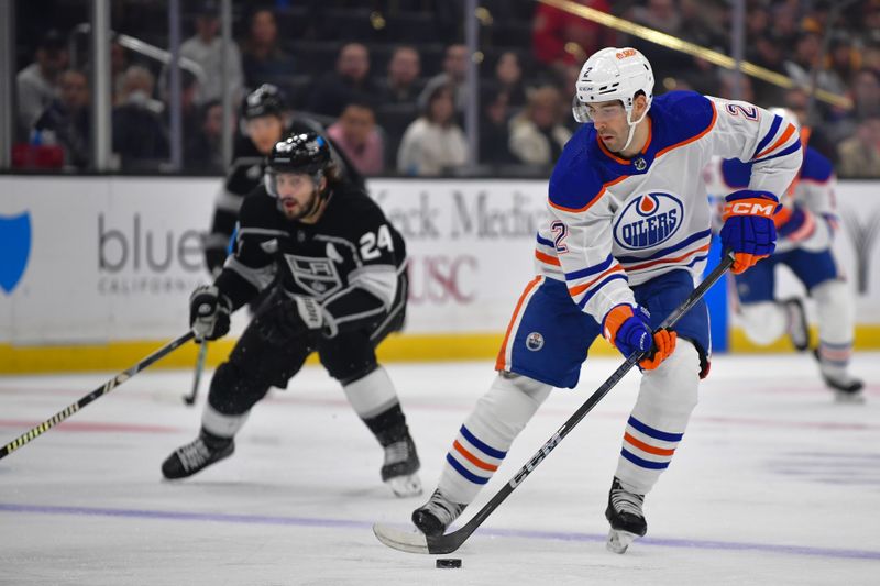 Dec 30, 2023; Los Angeles, California, USA; Edmonton Oilers defenseman Evan Bouchard (2) moves the puck against the Los Angeles Kings during the first period at Crypto.com Arena. Mandatory Credit: Gary A. Vasquez-USA TODAY Sports