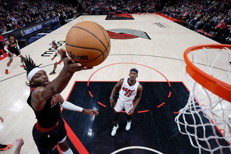 PORTLAND, OREGON - FEBRUARY 27: Jerami Grant #9 of the Portland Trail Blazers shoots the ball as Jimmy Butler #22 of the Miami Heat looks on during the first half at Moda Center on February 27, 2024 in Portland, Oregon. NOTE TO USER: User expressly acknowledges and agrees that, by downloading and or using this photograph, User is consenting to the terms and conditions of the Getty Images License Agreement. (Photo by Soobum Im/Getty Images)