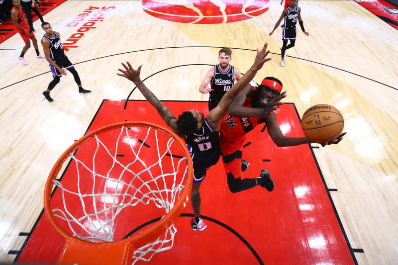 TORONTO, CANADA - MARCH 20: Mouhamadou Gueye #16 of the Toronto Raptors drives to the basket during the game against the Sacramento Kings on March 20, 2024 at the Scotiabank Arena in Toronto, Ontario, Canada.  NOTE TO USER: User expressly acknowledges and agrees that, by downloading and or using this Photograph, user is consenting to the terms and conditions of the Getty Images License Agreement.  Mandatory Copyright Notice: Copyright 2024 NBAE (Photo by Vaughn Ridley/NBAE via Getty Images)