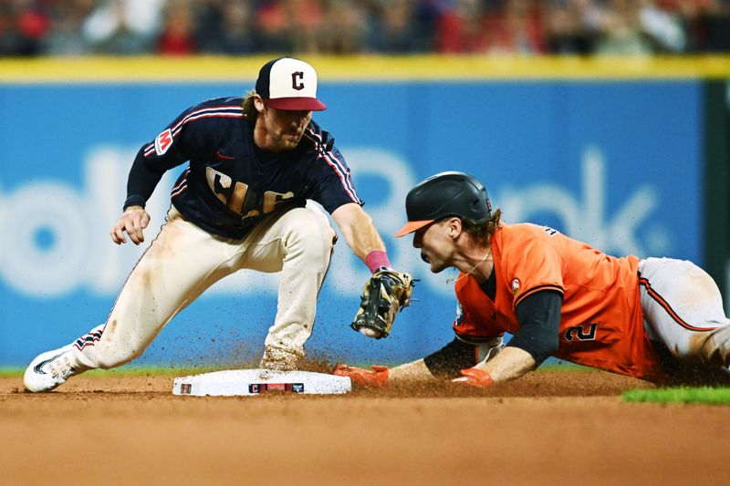 Aug 3, 2024; Cleveland, Ohio, USA; Baltimore Orioles shortstop Gunnar Henderson (2) slides into second with a double as Cleveland Guardians shortstop Daniel Schneemann (10) is late with the tag during the eighth inning at Progressive Field. Mandatory Credit: Ken Blaze-USA TODAY Sports