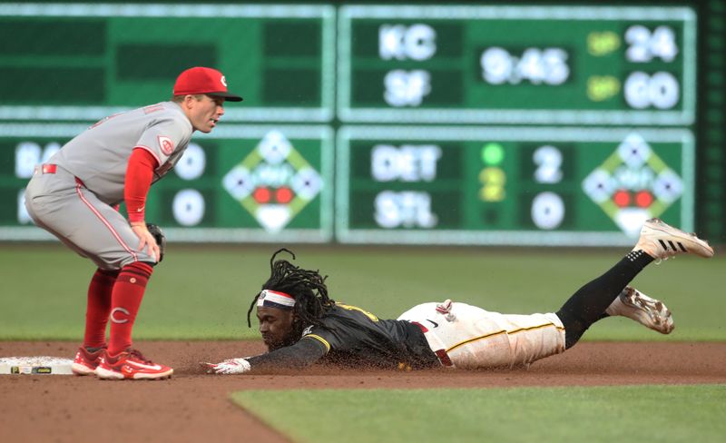 May 20, 2025; Pittsburgh, Pennsylvania, USA; Pittsburgh Pirates center fielder Oneil Cruz (15) steals second base as Cincinnati Reds second baseman Matt McLain (9) waits for a throw during the sixth inning during the sixth inning at PNC Park. Mandatory Credit: Charles LeClaire-Imagn Images