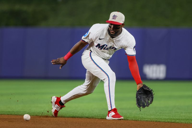 Jul 4, 2024; Miami, Florida, USA; Miami Marlins shortstop Vidal Brujan (17) catches a ground ball to retire Boston Red Sox second baseman David Hamilton (70) during the third inning at loanDepot Park. Mandatory Credit: Sam Navarro-USA TODAY Sports