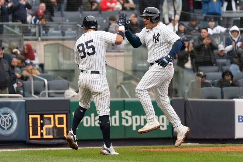 Apr 5, 2023; Bronx, New York, USA; New York Yankees left fielder Oswaldo Cabrera (95) congratulates New York Yankees catcher Jose Trevino (39) for hitting a two run home run against the Philadelphia Phillies during the seventh inning at Yankee Stadium. Mandatory Credit: Gregory Fisher-USA TODAY Sports