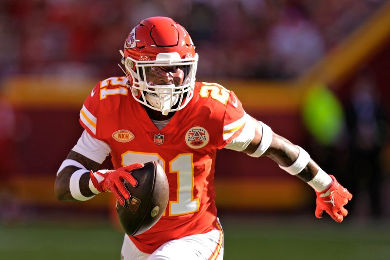 Kansas City Chiefs safety Mike Edwards runs the ball after intercepting a pass during the first half of an NFL football game against the Chicago Bears Sunday, Sept. 24, 2023, in Kansas City, Mo. (AP Photo/Charlie Riedel)