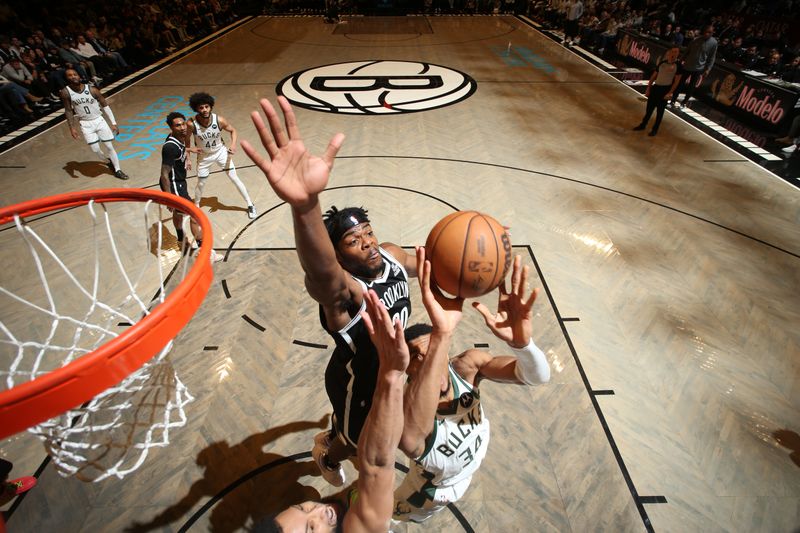 BROOKLYN, NY - DECEMBER 8: Day'Ron Sharpe #20 of the Brooklyn Nets attempts to block a shot from Giannis Antetokounmpo #34 of the Milwaukee Bucks during the game on December 8, 2024 at Barclays Center in Brooklyn, New York. NOTE TO USER: User expressly acknowledges and agrees that, by downloading and or using this Photograph, user is consenting to the terms and conditions of the Getty Images License Agreement. Mandatory Copyright Notice: Copyright 2024 NBAE (Photo by Nathaniel S. Butler/NBAE via Getty Images)