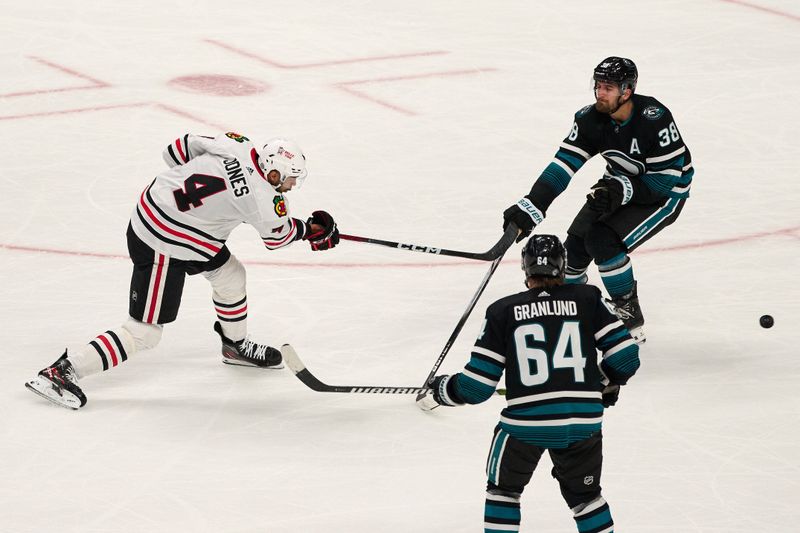 Mar 23, 2024; San Jose, California, USA; Chicago Blackhawks defenseman Seth Jones (4) scores the game-winning goal against the San Jose Sharks during the overtime period at SAP Center at San Jose. Mandatory Credit: Robert Edwards-USA TODAY Sports