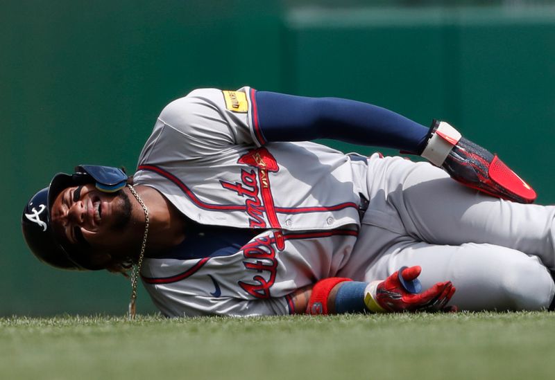 May 26, 2024; Pittsburgh, Pennsylvania, USA;  Atlanta Braves right fielder Ronald Acuña Jr. (13) reacts after suffering an apparent injury on a steal attempt against the Pittsburgh Pirates during the first inning at PNC Park. Mandatory Credit: Charles LeClaire-USA TODAY Sports