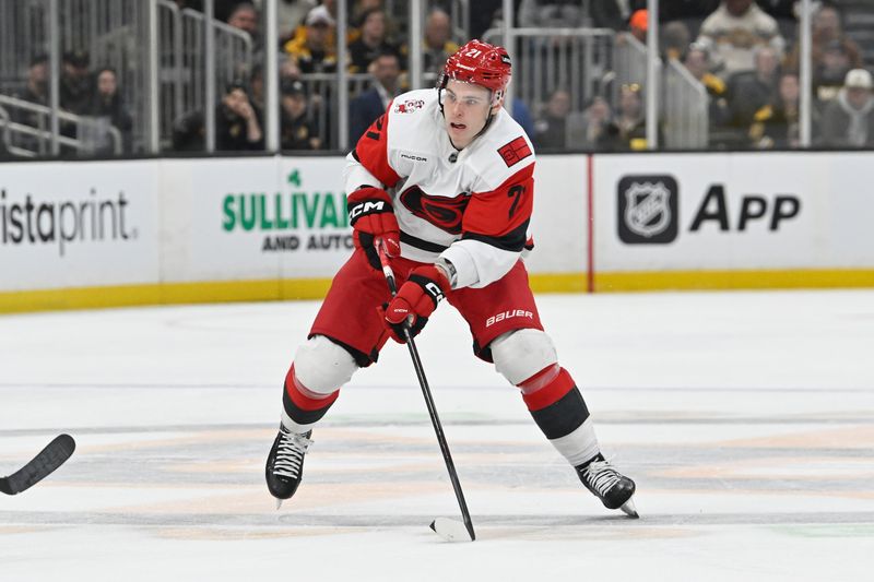 Nov 1, 2025; Boston, Massachusetts, USA; Carolina Hurricanes defenseman Alexander Nikishin (21) carries the puck through the neutral zone during the second period against the Boston Bruins at TD Garden. Mandatory Credit: Eric Canha-Imagn Images