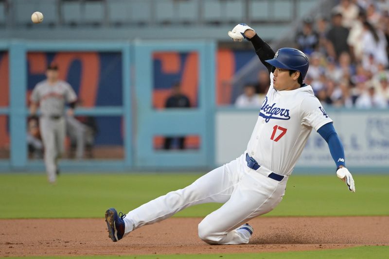 Jul 22, 2024; Los Angeles, California, USA;  Los Angeles Dodgers designated hitter Shohei Ohtani (17) is caught stealing on a tag by San Francisco Giants shortstop Brett Wisely (0) in the first inning at Dodger Stadium. Mandatory Credit: Jayne Kamin-Oncea-USA TODAY Sports