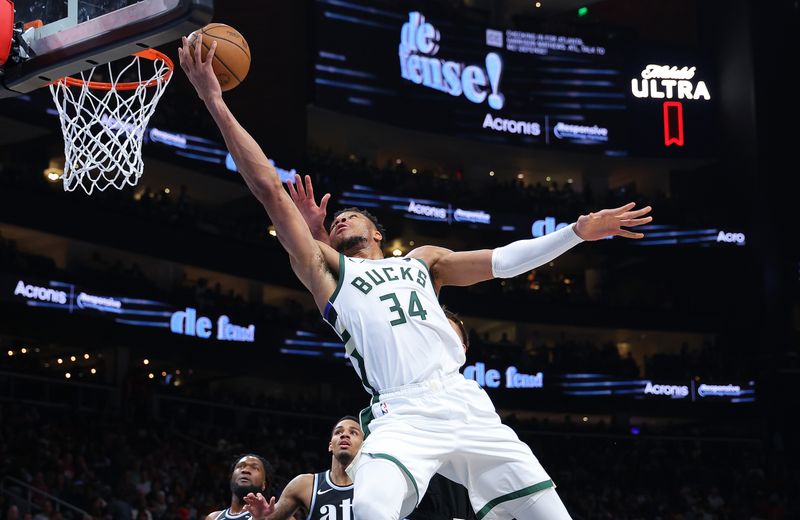 ATLANTA, GEORGIA - MARCH 30:  Giannis Antetokounmpo #34 of the Milwaukee Bucks drives against Bogdan Bogdanovic #13 of the Atlanta Hawks during the second quarter at State Farm Arena on March 30, 2024 in Atlanta, Georgia.  NOTE TO USER: User expressly acknowledges and agrees that, by downloading and/or using this photograph, user is consenting to the terms and conditions of the Getty Images License Agreement.  (Photo by Kevin C. Cox/Getty Images)