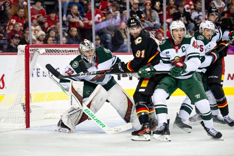 Nov 23, 2024; Calgary, Alberta, CAN; Minnesota Wild goaltender Filip Gustavsson (32) looks around Calgary Flames center Nazem Kadri (91) to find the puck during the second period at Scotiabank Saddledome. Mandatory Credit: Brett Holmes-Imagn Images