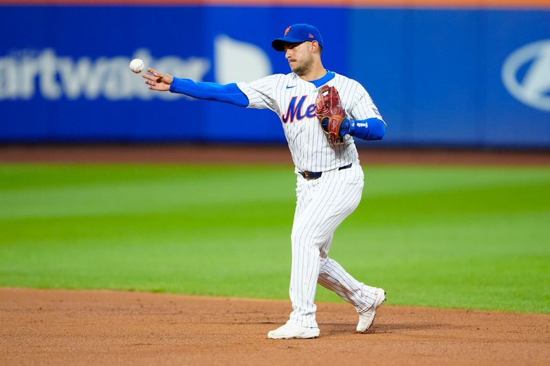 Aug 19, 2024; New York City, New York, USA; New York Mets second baseman Jose Iglesias (11) throws out Baltimore Orioles right fielder Anthony Santander (not pictured) after fielding a ground ball during the second inning at Citi Field. Mandatory Credit: Gregory Fisher-USA TODAY Sports