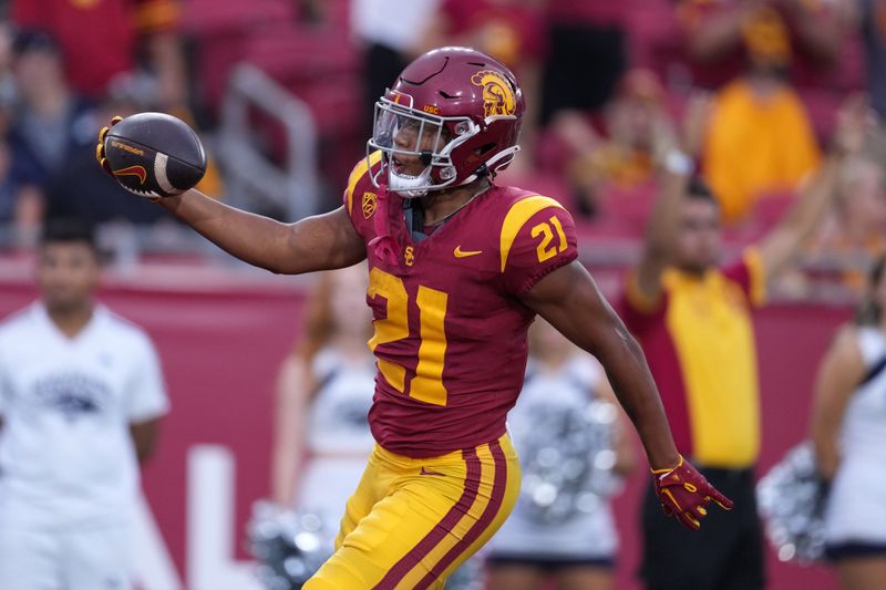 Sep 2, 2023; Los Angeles, California, USA; Southern California Trojans running back Quinten Joyner (21) scores on a 47-yard touchdown run against the Nevada Wolf Pack in the second half at United Airlines Field at Los Angeles Memorial Coliseum. Mandatory Credit: Kirby Lee-USA TODAY Sports