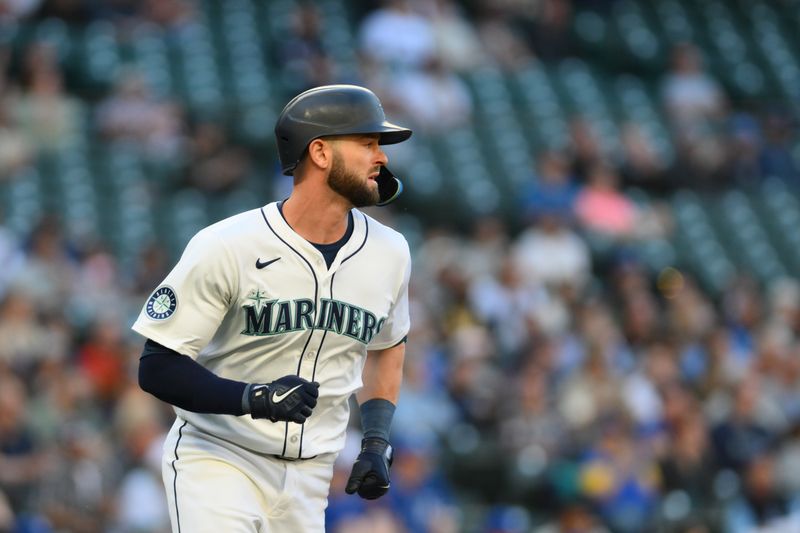 May 14, 2024; Seattle, Washington, USA; Seattle Mariners right fielder Mitch Haniger (17) runs towards first base after hitting a single against the Kansas City Royals during the second inning at T-Mobile Park. Mandatory Credit: Steven Bisig-USA TODAY Sports