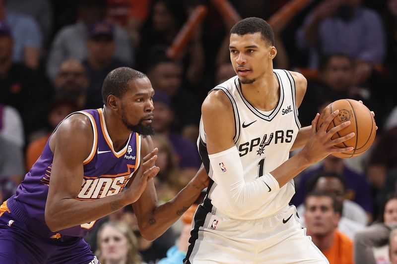 PHOENIX, ARIZONA - NOVEMBER 02:  Victor Wembanyama #1 of the San Antonio Spurs handles the ball against Kevin Durant #35 of the Phoenix Suns during the second half of the NBA game at Footprint Center on November 02, 2023 in Phoenix, Arizona. The Spurs defeated the Suns 132-121.  NOTE TO USER: User expressly acknowledges and agrees that, by downloading and or using this photograph, User is consenting to the terms and conditions of the Getty Images License Agreement.  (Photo by Christian Petersen/Getty Images)