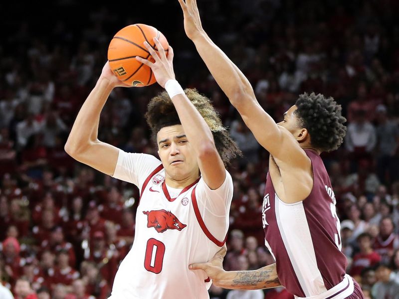 Feb 11, 2023; Fayetteville, Arkansas, USA; Arkansas Razorbacks guard Anthony Black (0) drives against  Mississippi State Bulldogs guard Shakeel Moore (3) during the first half at Bud Walton Arena. Mandatory Credit: Nelson Chenault-USA TODAY Sports