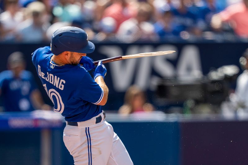 Aug 13, 2023; Toronto, Ontario, CAN; Toronto Blue Jays shortstop Paul DeJong (10) breaks his bat during the fifth inning the Chicago Cubs at Rogers Centre. Mandatory Credit: Kevin Sousa-USA TODAY Sports