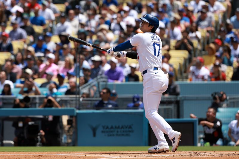 May 5, 2024; Los Angeles, California, USA;  Los Angeles Dodgers designated hitter Shohei Ohtani (17) hits a home run during the first inning against the Atlanta Braves at Dodger Stadium. Mandatory Credit: Kiyoshi Mio-USA TODAY Sports