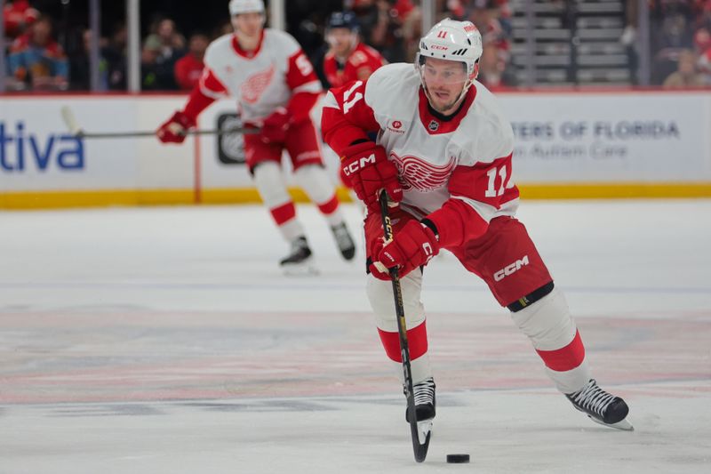 Jan 16, 2025; Sunrise, Florida, USA; Detroit Red Wings right wing Vladimir Tarasenko (11) moves the puck against the Florida Panthers during the first period at Amerant Bank Arena. Mandatory Credit: Sam Navarro-Imagn Images