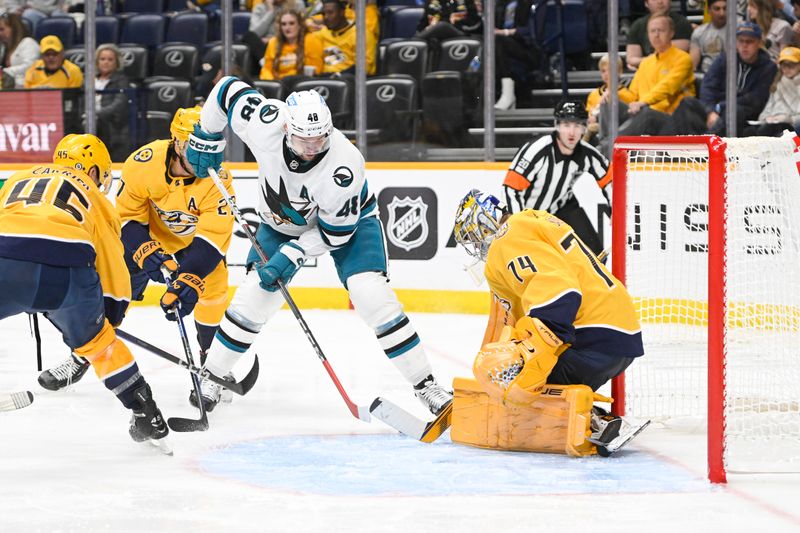 Oct 21, 2023; Nashville, Tennessee, USA; Nashville Predators goaltender Juuse Saros (74) blocks the shot of San Jose Sharks center Tomas Hertl (48) during the second period at Bridgestone Arena. Mandatory Credit: Steve Roberts-USA TODAY Sports