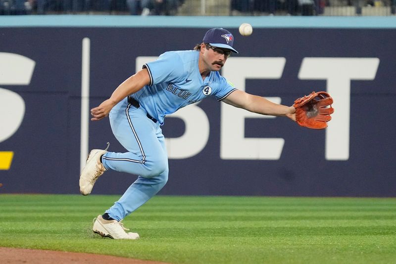 Jun 1, 2025; Toronto, Ontario, CAN; Toronto Blue Jays second baseman Davis Schneider (36) can't reach a ball hit by Oakland Athletics shortstop Jacob Wilson (not pictured) during the first inning at Rogers Centre. Mandatory Credit: John E. Sokolowski-Imagn Images