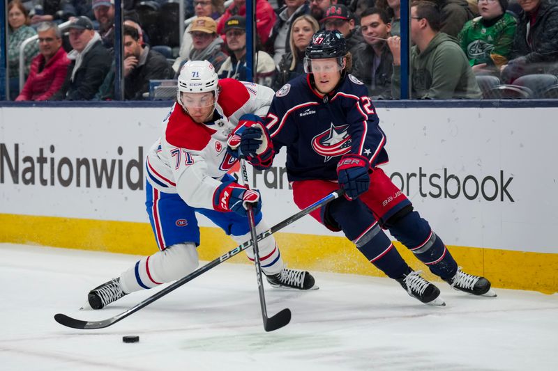 Nov 29, 2023; Columbus, Ohio, USA;  Montreal Canadiens center Jake Evans (71) skates for the puck against Columbus Blue Jackets defenseman Adam Boqvist (27) in the first period at Nationwide Arena. Mandatory Credit: Aaron Doster-USA TODAY Sports