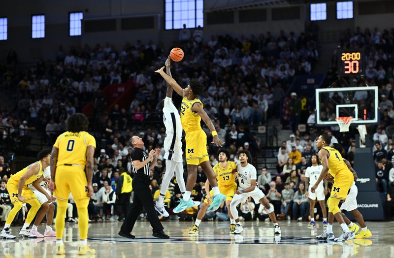 Jan 7, 2024; Philadelphia, Pennsylvania, USA; Penn State Nittany Lions forward Qudus Wahab (22) and Michigan Wolverines forward Tarris Reed Jr (32) battle for the tip-off in the first half at The Palestra. Mandatory Credit: Kyle Ross-USA TODAY Sports